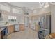Spacious kitchen with stainless steel appliances, light wood cabinets, and a neutral tile floor at 6664 Deering Cir, Sarasota, FL 34240