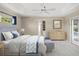 Serene main bedroom with a tray ceiling, a private door to the pool, and a spa-like ensuite at 6664 Deering Cir, Sarasota, FL 34240