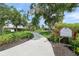 Scenic walkway winding through manicured lawns, leading to community amenities in Deerfield at 6664 Deering Cir, Sarasota, FL 34240