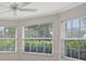 Bright room featuring three large windows offering abundant natural light and views of the lush greenery outside at 6664 Deering Cir, Sarasota, FL 34240