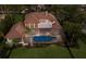 Bird's-eye view of a property featuring a private pool, well-maintained yard, and surrounding greenery at 6919 Westchester Cir, Lakewood Ranch, FL 34202