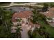 Expansive aerial shot showcasing the home's lush landscaping and prime location near water and golf course at 6919 Westchester Cir, Lakewood Ranch, FL 34202