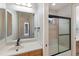 Bathroom featuring vanity, a toilet, and a tiled shower with glass door at 6919 Westchester Cir, Lakewood Ranch, FL 34202