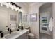 Elegant bathroom featuring a large mirror, vanity with flower accent, and access to the screened pool area at 6919 Westchester Cir, Lakewood Ranch, FL 34202
