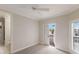 Minimalist bedroom with private balcony access and shuttered windows offers a serene, light-filled space at 6919 Westchester Cir, Lakewood Ranch, FL 34202