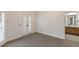 Spacious bedroom featuring carpet floors, white french doors, and an ensuite bathroom at 6919 Westchester Cir, Lakewood Ranch, FL 34202