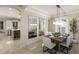 Bright dining room adjacent to kitchen featuring modern decor, updated lighting, and large mirror at 6919 Westchester Cir, Lakewood Ranch, FL 34202