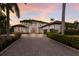 Elegant two-story home featuring a paved driveway, manicured landscaping, and a stately facade at 6919 Westchester Cir, Lakewood Ranch, FL 34202