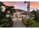 Majestic two-story home featuring a brick driveway, lush landscaping, and a grand entrance with columns at 6919 Westchester Cir, Lakewood Ranch, FL 34202