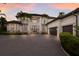 Elegant two-story home featuring a paved driveway, manicured landscaping, and a stately facade at 6919 Westchester Cir, Lakewood Ranch, FL 34202