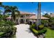 Desirable property showcasing mature palms, manicured landscaping, and a barrel tile roof for a timeless look at 6919 Westchester Cir, Lakewood Ranch, FL 34202