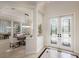 Grand entryway featuring tiled floors, double doors with decorative glass, and a dining area with modern lighting at 6919 Westchester Cir, Lakewood Ranch, FL 34202