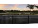 Panoramic view of lush green golf course and calm pond visible beyond the balcony railing at 6919 Westchester Cir, Lakewood Ranch, FL 34202