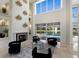 Bright living space with floor-to-ceiling windows, a fireplace, and views of the pool and landscaped backyard at 6919 Westchester Cir, Lakewood Ranch, FL 34202