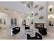 Open-concept living room with high ceilings, fireplace, decorative wall accents, and natural light at 6919 Westchester Cir, Lakewood Ranch, FL 34202