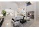 Open-concept living room featuring sleek tile floors, a staircase, and abundant natural light at 6919 Westchester Cir, Lakewood Ranch, FL 34202