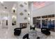 Bright living room with fireplace, high ceilings, a decorative wall, and sliding glass doors to the pool at 6919 Westchester Cir, Lakewood Ranch, FL 34202