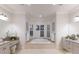 Bright primary bathroom featuring dual vanities, a soaking tub nestled within a window-lit alcove at 6919 Westchester Cir, Lakewood Ranch, FL 34202