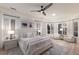 Spacious primary bedroom with neutral tones, a large bed, and a bay window seating area with shutters at 6919 Westchester Cir, Lakewood Ranch, FL 34202