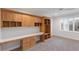 Bright office featuring custom cabinetry, built-in desk, and shuttered windows allowing ample natural light at 6919 Westchester Cir, Lakewood Ranch, FL 34202
