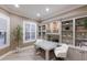 Well-lit office space with built-in shelving, a glass-top desk, and a large window with shutters at 6919 Westchester Cir, Lakewood Ranch, FL 34202