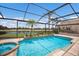 Screened-in pool with spa, fountain features, and view of the golf course and pond at 6919 Westchester Cir, Lakewood Ranch, FL 34202