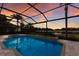 Tranquil backyard pool and jacuzzi offer golf course views in screened enclosure at 6919 Westchester Cir, Lakewood Ranch, FL 34202