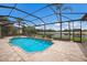 Screened-in pool with spa, fountain feature, and view of the golf course and pond at 6919 Westchester Cir, Lakewood Ranch, FL 34202