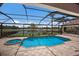 Screened pool with spa, fountain features, and view of the golf course and pond at 6919 Westchester Cir, Lakewood Ranch, FL 34202