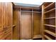 Spacious walk-in closet with custom shelving and wood finishes; perfect for organization and storage at 6919 Westchester Cir, Lakewood Ranch, FL 34202