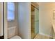 Bathroom featuring a toilet and tiled glass-doored shower with neutral paint and finishes at 7719 9Th Avenue Nw Dr, Bradenton, FL 34209