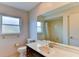 Bathroom with a large mirror, a sink with a marble-like countertop, and natural light from the window at 7719 9Th Avenue Nw Dr, Bradenton, FL 34209