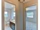View of a bathroom and bedroom with neutral walls and tiled flooring at 7719 9Th Avenue Nw Dr, Bradenton, FL 34209