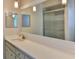 Bright bathroom with white countertop vanity, large mirror, and glass-enclosed shower at 7719 9Th Avenue Nw Dr, Bradenton, FL 34209