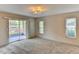 Bedroom featuring carpeting and sliding glass doors leading to a patio at 7719 9Th Avenue Nw Dr, Bradenton, FL 34209