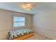 Bedroom features a window, modern ceiling light and a bed platform with drawers at 7719 9Th Avenue Nw Dr, Bradenton, FL 34209