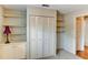 Bedroom featuring built in shelves, storage and closet with shutter doors at 7719 9Th Avenue Nw Dr, Bradenton, FL 34209