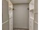 Spacious walk-in closet featuring white shelving and hanging rods at 7719 9Th Avenue Nw Dr, Bradenton, FL 34209