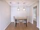 Dining area features wood floors, hanging lantern lighting, and neutral walls at 7719 9Th Avenue Nw Dr, Bradenton, FL 34209