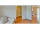 Neutral interior showcasing hardwood floors, light-filled openings, and a glimpse of a cozy living space with comfortable seating at 7719 9Th Avenue Nw Dr, Bradenton, FL 34209
