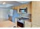 Kitchen featuring stainless steel appliances, wood cabinets, and tile backsplash at 7719 9Th Avenue Nw Dr, Bradenton, FL 34209