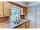 Kitchen featuring stainless steel appliances and a double sink overlooking the backyard at 7719 9Th Avenue Nw Dr, Bradenton, FL 34209
