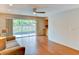 Open living room with hardwood floors, sliding glass door to the patio, and built in cabinet at 7719 9Th Avenue Nw Dr, Bradenton, FL 34209