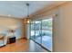 Bright living room with laminate floors and sliding glass doors leading to screened-in patio and pool at 7719 9Th Avenue Nw Dr, Bradenton, FL 34209