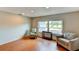 Bright living room with neutral walls, recessed lights, wood floors, and ample natural light through a large window at 7719 9Th Avenue Nw Dr, Bradenton, FL 34209