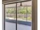View from interior looking out to screened-in patio with ceiling fan and swimming pool at 7719 9Th Avenue Nw Dr, Bradenton, FL 34209