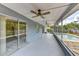 Enclosed patio with ceiling fans and sliding glass door to the pool at 7719 9Th Avenue Nw Dr, Bradenton, FL 34209