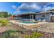 Backyard with a kidney-shaped swimming pool, a screened lanai, and well-maintained landscaping at 7719 9Th Avenue Nw Dr, Bradenton, FL 34209