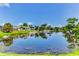 Picturesque waterfront property with lush greenery and homes reflected in the serene water at 7719 9Th Avenue Nw Dr, Bradenton, FL 34209