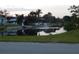 A tranquil waterfront view features lush trees, manicured lawns, and a charming fountain feature at 7719 9Th Avenue Nw Dr, Bradenton, FL 34209